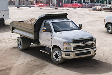 Three Chevrolet Silverado HD trucks on a construction site